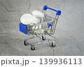 Led light bulbs in a shopping cart on a concrete gray background. 139936113
