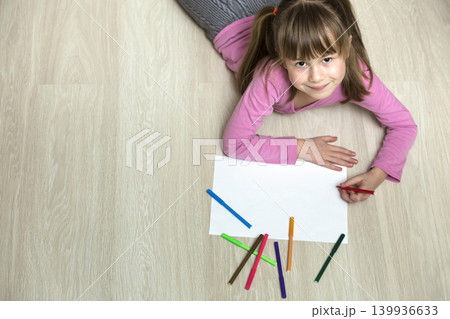 Cute child girl drawing with colorful pencils crayons on white paper. Art education, creativity concept. Cute child girl drawing with colorful pencils crayons on white paper. Art education, creativity concept. 139936633