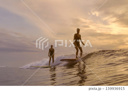 Woman Maintaining Steady Stance On Longboard During Sunset Over Tranquil Sea Woman Maintaining Steady Stance On Longboard During Sunset Over Tranquil Sea 139936915
