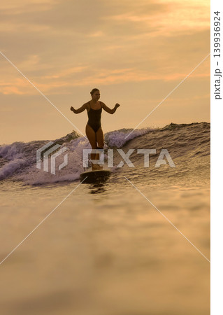Gracious Lady Maintains Perfect Balance On Her Longboard Beneath Setting Sun Gracious Lady Maintains Perfect Balance On Her Longboard Beneath Setting Sun 139936924