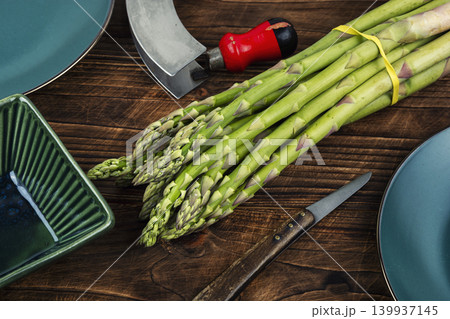 Spring green asparagus bunch on kitchen background Spring green asparagus bunch on kitchen background 139937145