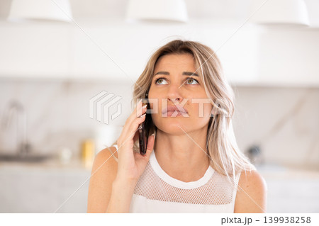 conversing on phone with discernible tone 139938258