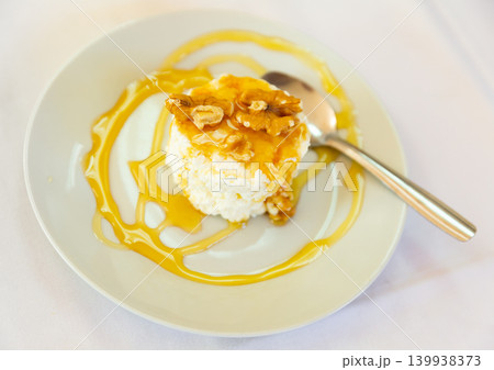 Fresh cottage cheese with honey and walnuts Fresh cottage cheese with honey and walnuts 139938373