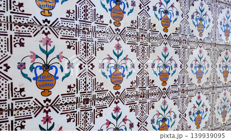 Traditional Portuguese azulejo tiles with painted vase and floral patterns 139939095