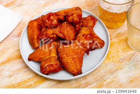 Service plate containing smoked chicken wings with necessary table laying Service plate containing smoked chicken wings with necessary table laying 139941649