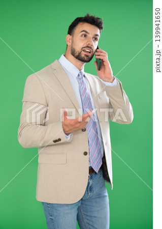 Adult positive man talks emotionally on mobile phone. Chroma key compositing. 139941650