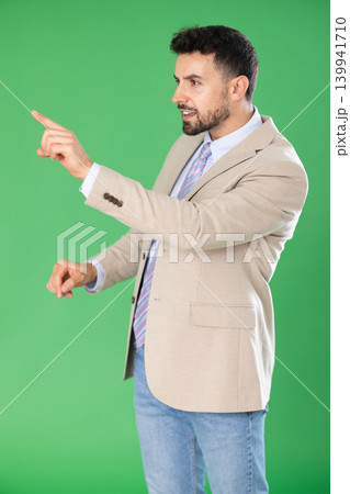 Adult man presses buttons on virtual screen and expresses various emotions. Chroma key compositing. 139941710