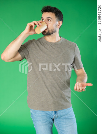 Young man and coffee break on green screen background 139941726