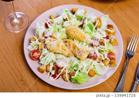 Caesar salad with chicken and parmesan cheese Caesar salad with chicken and parmesan cheese 139941728