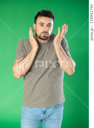 Adult man sad and upset in front of green screen Adult man sad and upset in front of green screen 139941740