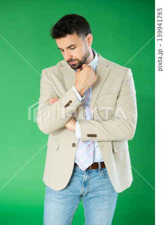 Portrait of sad adult man on green background. Chroma key compositing 139941765