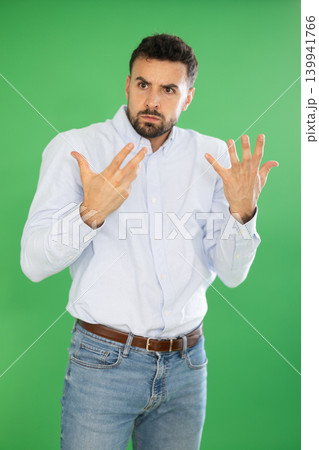 Adult man confused and forgetful in front of green screen Adult man confused and forgetful in front of green screen 139941766