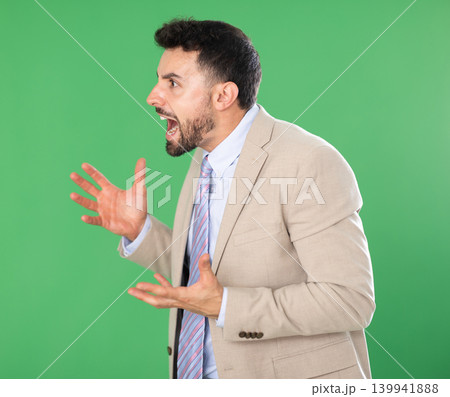Adult man angry and yelling in front of green screen 139941888