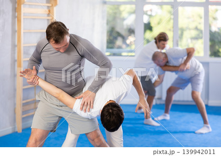 Two men training judo technique in studio 139942011