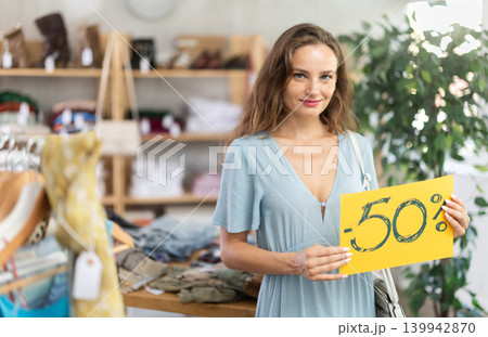 Woman holding poster with 50 percent discount 139942870