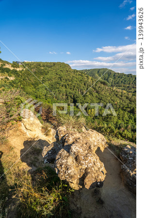 Majestic rocky cliffs and towering pine trees against blue sky. Majestic rocky cliffs and towering pine trees against blue sky. 139943626