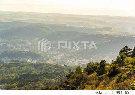Layers of green mountains and hills in the haze during sunset. Panoramic View of Green hills and Meadow. 139943650