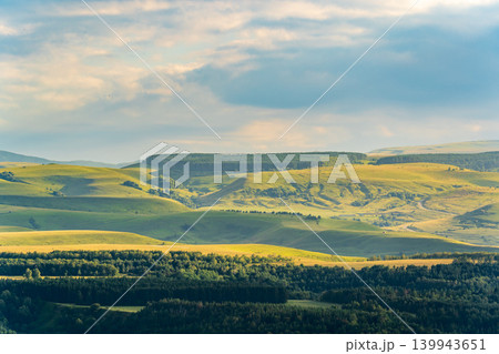 Layers of green mountains and hills in the haze during sunset. Panoramic View of Green hills and Meadow. Layers of green mountains and hills in the haze during sunset. Panoramic View of Green hills and Meadow. 139943651