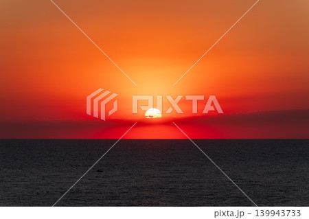 Beautiful red and orange sunrise over the sea. Beautiful red and orange sunrise over the sea. 139943733