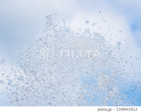 Splashes and jets of water against light background. Splashes and jets of water against light background. 139943912
