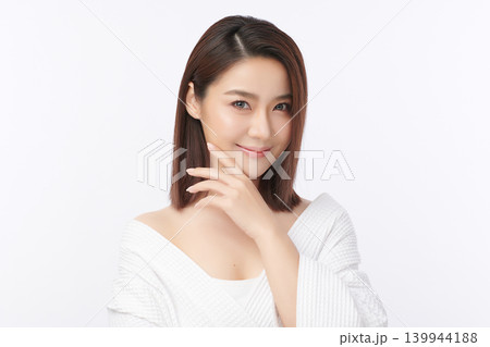 A beautiful young Asian woman with clean, fresh skin against a white background. Skincare, facial treatment, cosmetology, beauty, and spa. An elegant portrait of an Asian woman. 139944188