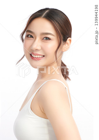 A beautiful young Asian woman with clean, fresh skin against a white background. Skincare, facial treatment, cosmetology, beauty, and spa. An elegant portrait of an Asian woman. A beautiful young Asian woman with clean, fresh skin against a white background. Skincare, facial treatment, cosmetology, beauty, and spa. An elegant portrait of an Asian woman. 139944198