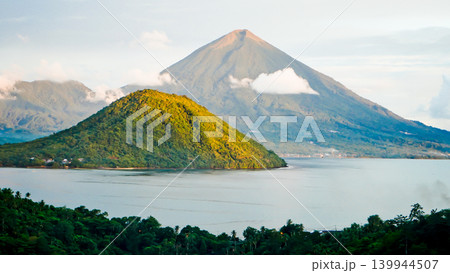 Beautiful view of Maitara Island and Tidore Island in the morning in summer, Ternate, Indonesia Beautiful view of Maitara Island and Tidore Island in the morning in summer, Ternate, Indonesia 139944507