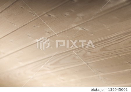 Close-up shot of light-colored wooden planks of ceiling 139945001