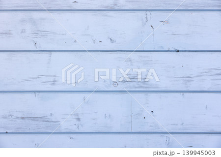 Light blue wooden wall with knots and cracks, front view Light blue wooden wall with knots and cracks, front view 139945003