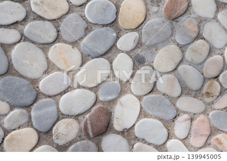 Smooth pebble mosaic floor top view. Rounded river stones 139945005