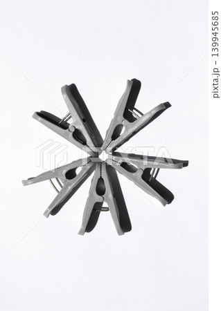 It is a clothespin placed on a white background. It is a clothespin placed on a white background. 139945685