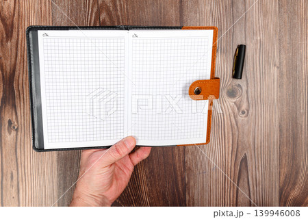 hand holding an open notebook hand holding an open notebook 139946008