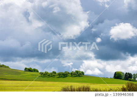 Green field landscape under cloudy sky photo Green field landscape under cloudy sky photo 139946368
