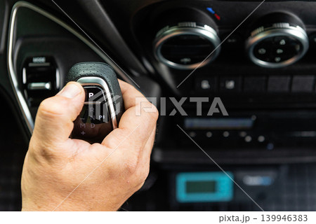 Man finger pressing button in car interior Man finger pressing button in car interior 139946383
