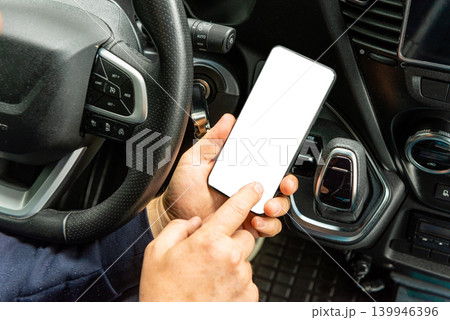 Man checking smartphone with white screen mockup Man checking smartphone with white screen mockup 139946396