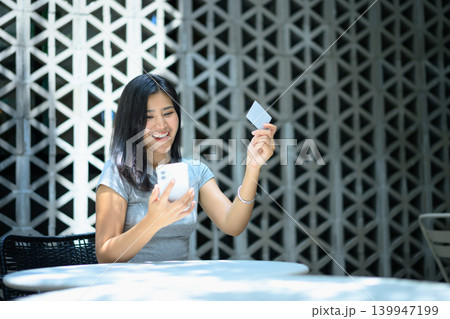 Asian woman using smartphone and credit card for online payment, enjoy moment shopping online 139947199