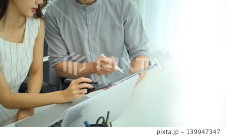 Close up of professionals comparing printed charts and digital data on digital tablet Close up of professionals comparing printed charts and digital data on digital tablet 139947347