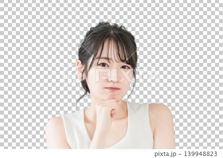 An Asian woman, resting her chin on her hand, ponders a problem (beauty, diet, spa treatments, hair removal). 139948823