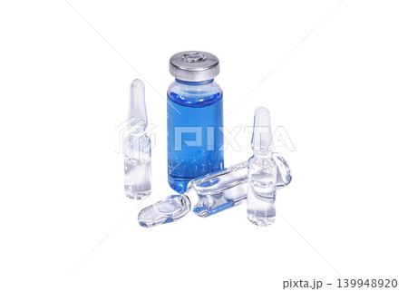 Medical vial with blue vaccine and ampoules on a white background Medical vial with blue vaccine and ampoules on a white background 139948920