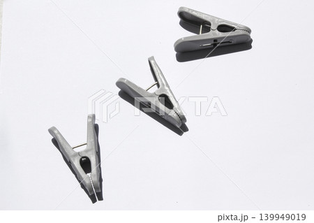 It is a clothespin placed on a white background It is a clothespin placed on a white background 139949019