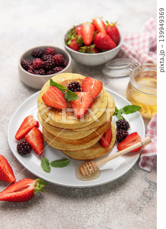 Stack of pancakes with fresh berries and honey for breakfast Stack of pancakes with fresh berries and honey for breakfast 139949369
