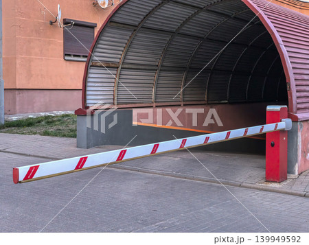 Close up of red and white automatic boom barrier at parking garage entrance 139949592