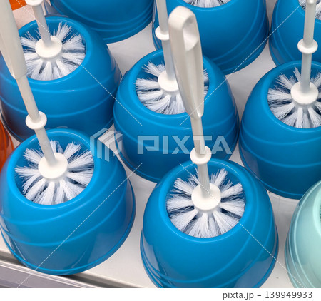 Blue toilet brush sets with white handles displayed on retail shelf Blue toilet brush sets with white handles displayed on retail shelf 139949933