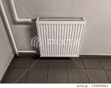 Central Heating Panel Radiator Mounted on Grey Corridor Wall 139949962