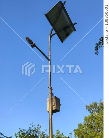 Solar panel street light pole with LED lamp and battery box closeup 139950001