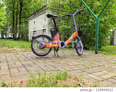 Low Angle Shot of Purple and Orange Rental Electric Bike Low Angle Shot of Purple and Orange Rental Electric Bike 139950012