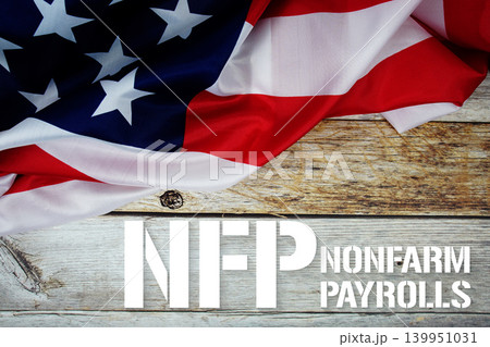 American flag with "NFP NONFARM PAYROLLS" on wooden background 139951031