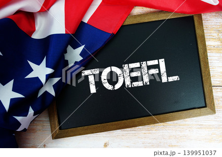 American flag with blackboard "TOEFL" on wooden background American flag with blackboard "TOEFL" on wooden background 139951037