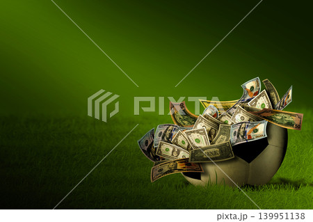 Soccer Ball Filled with US Dollar Bills on Green Grass - Sports Betting and Finance Concept Soccer Ball Filled with US Dollar Bills on Green Grass - Sports Betting and Finance Concept 139951138