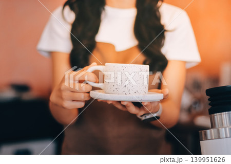 Young woman at barista school learning how to make espresso coffee. Young woman at barista school learning how to make espresso coffee. 139951626